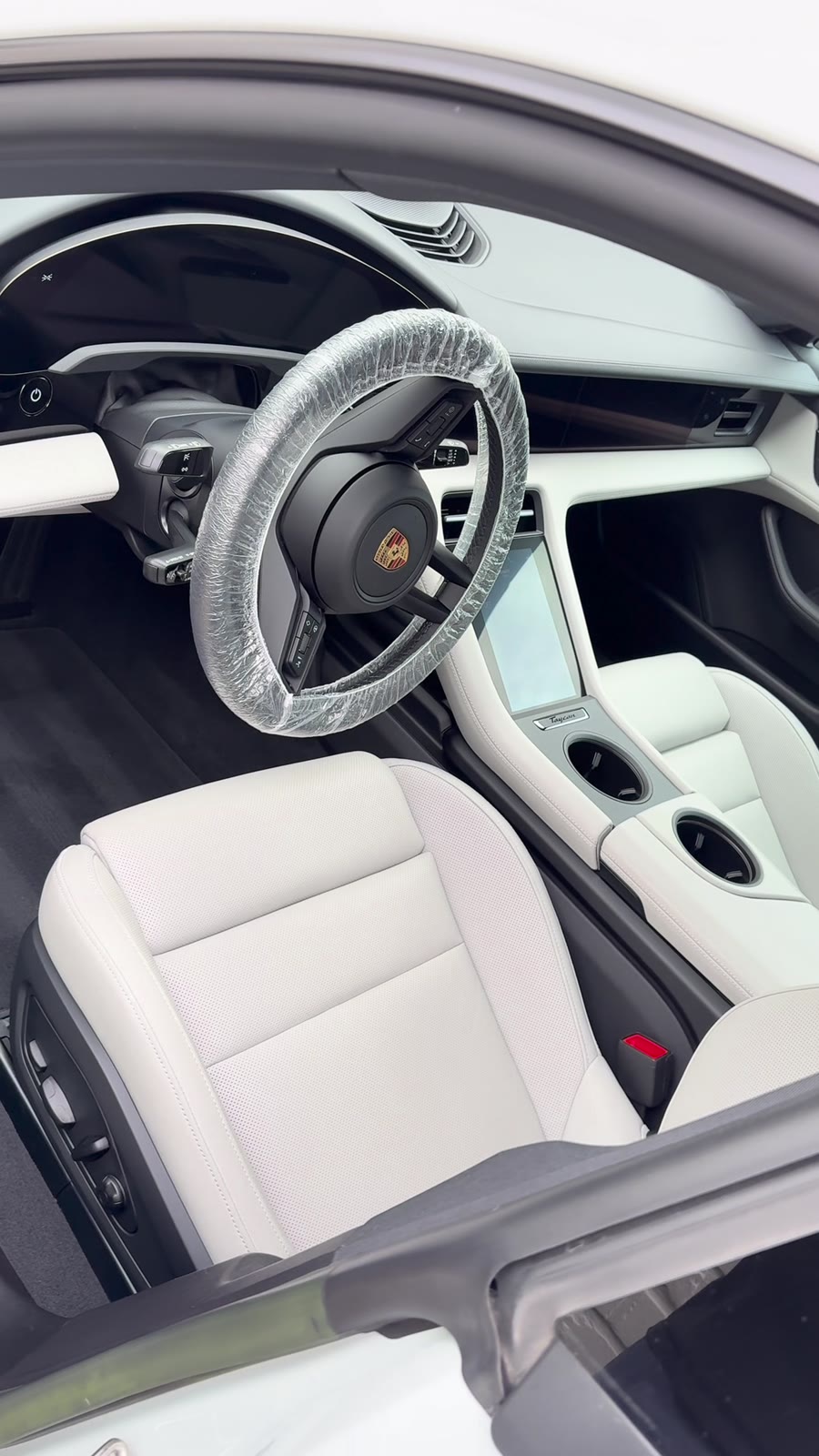 Spotless finished white leather interior of a Porsche Taycan after detailing