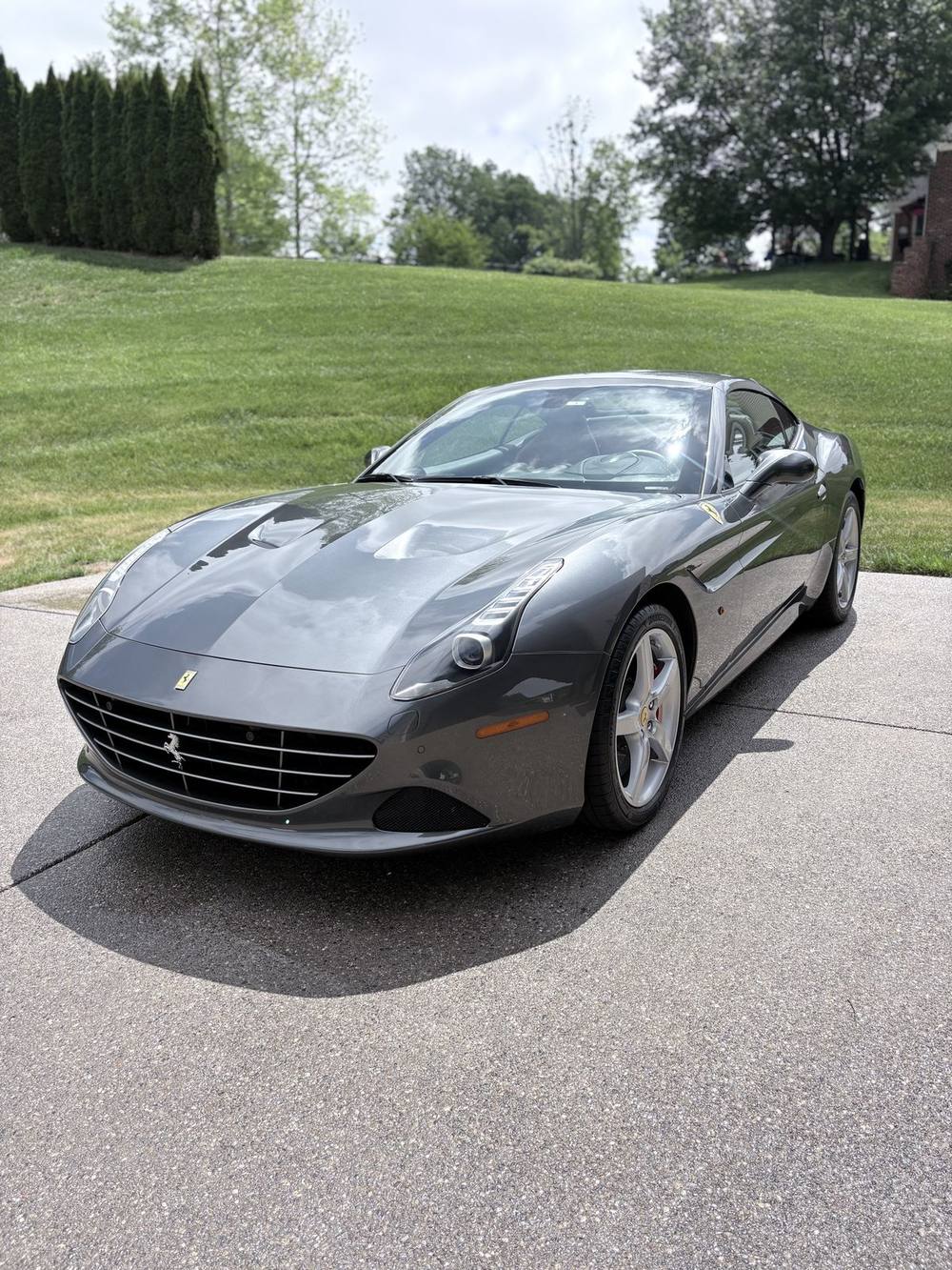 Gray Ferrari California detailed by Monster Car Detailing in a Louisville driveway