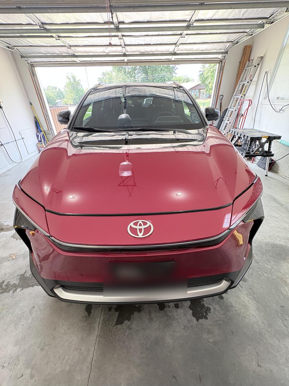 Red Toyota SUV gleaming in a garage after a complete Monster detail