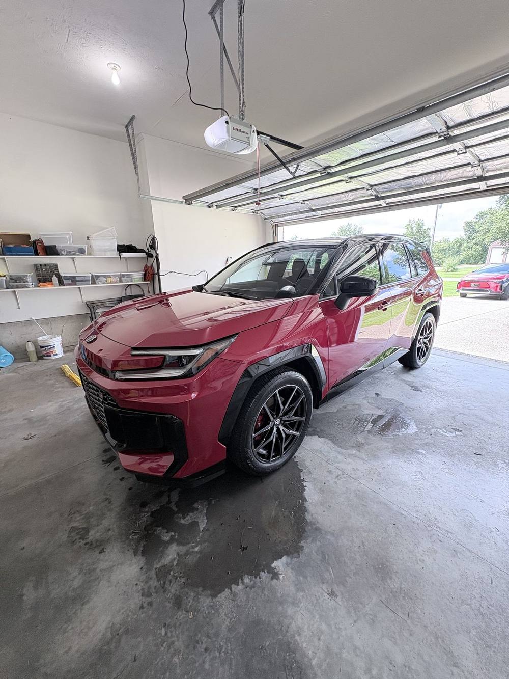 Red SUV being detailed inside a customer's garage